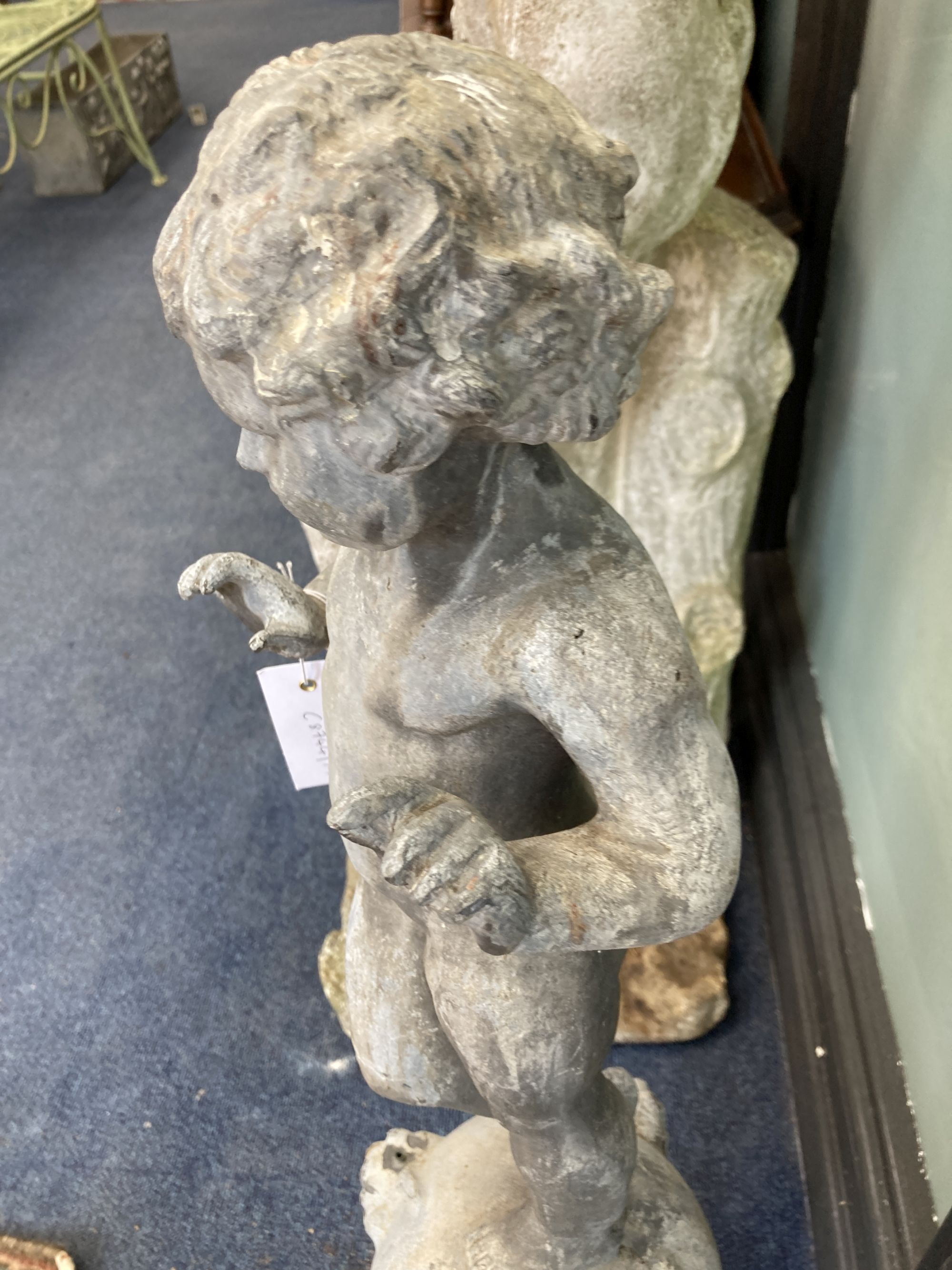 A Victorian lead garden ornament of a putto on orb, height 80cm